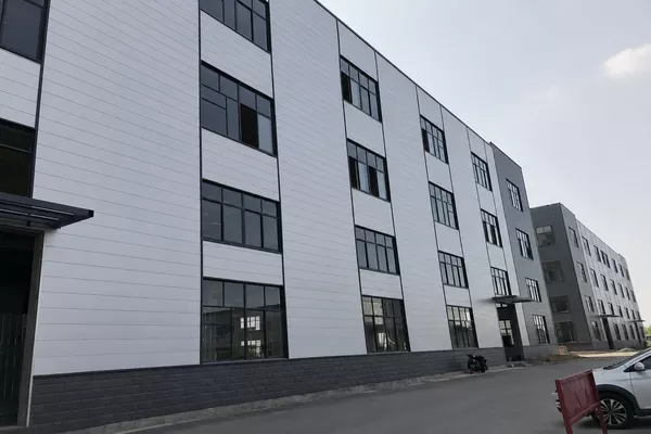 Flat metal siding panels installed on a modern commercial exterior building facade Flat metal siding panels installed on a modern commercial exterior building facade